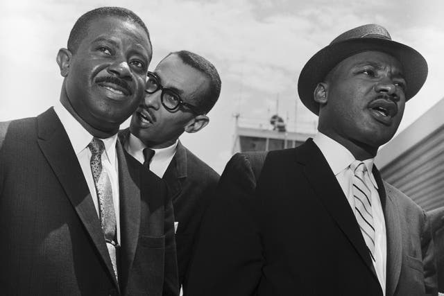 Walker (centre) in 1961 with Martin Luther King Jr (right) and Rev Ralph Abernathy shortly before King addressed crowds in Montgomery, Alabama following an outbreak of racial violence