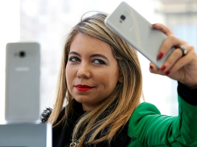 A woman takes a selfie with a Samsung Galaxy S8 smartphone during the Samsung Unpacked event in New York City, in March 2017