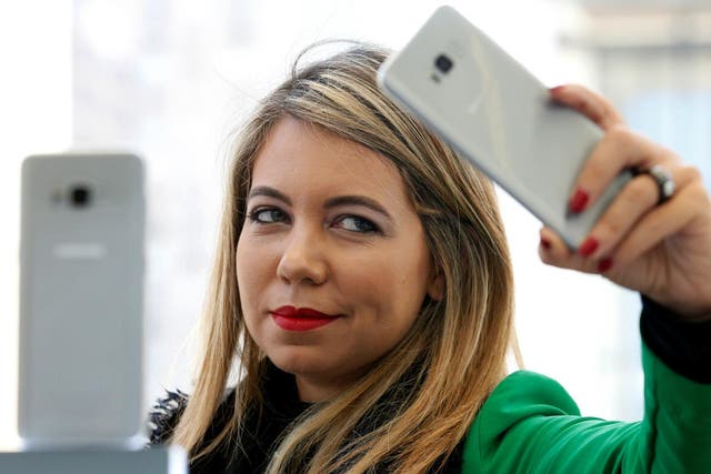 A woman takes a selfie with a Samsung Galaxy S8 smartphone during the Samsung Unpacked event in New York City, in March 2017