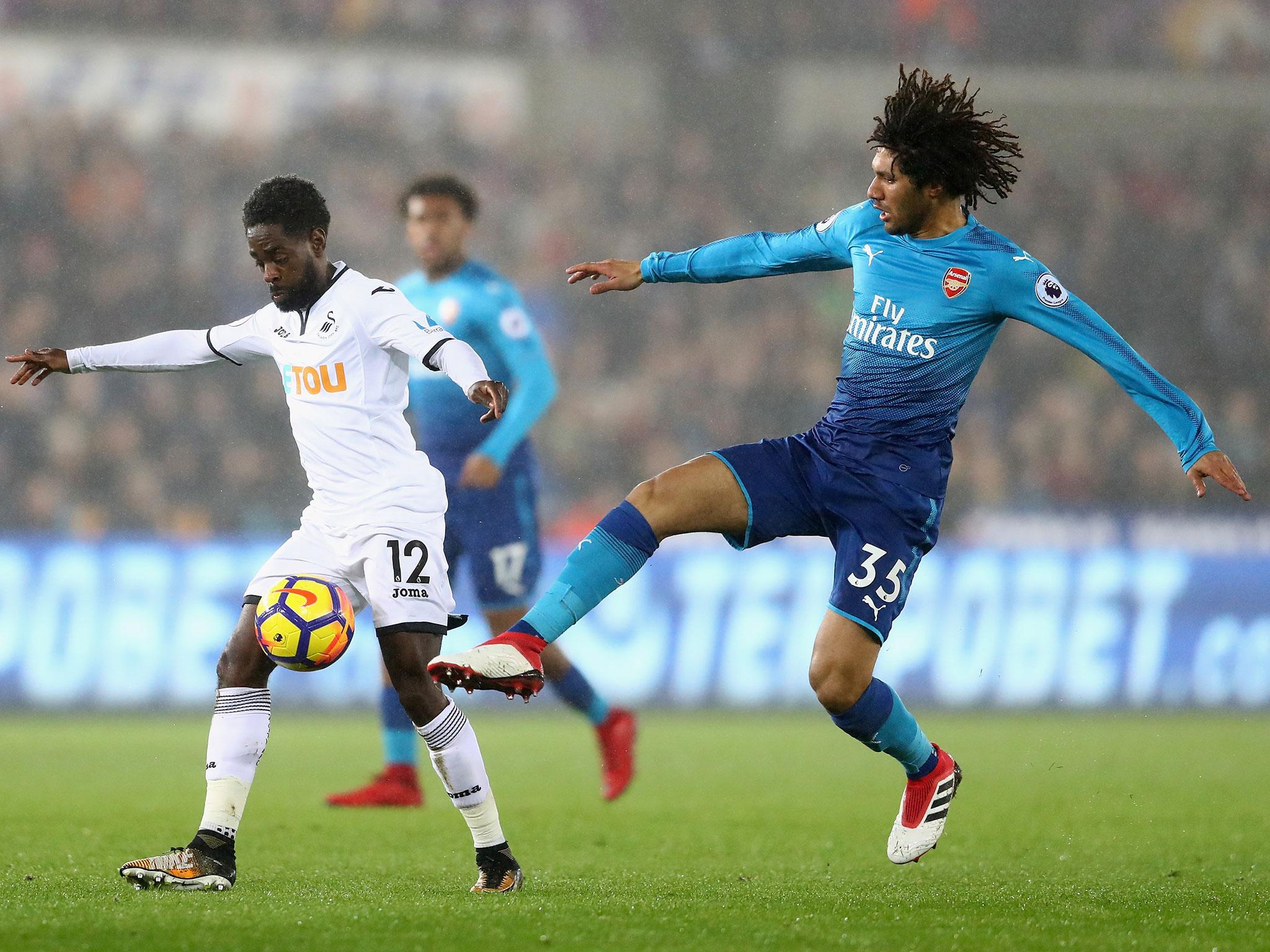 Nathan Dyer and Mohamed Elneny tussle for possession