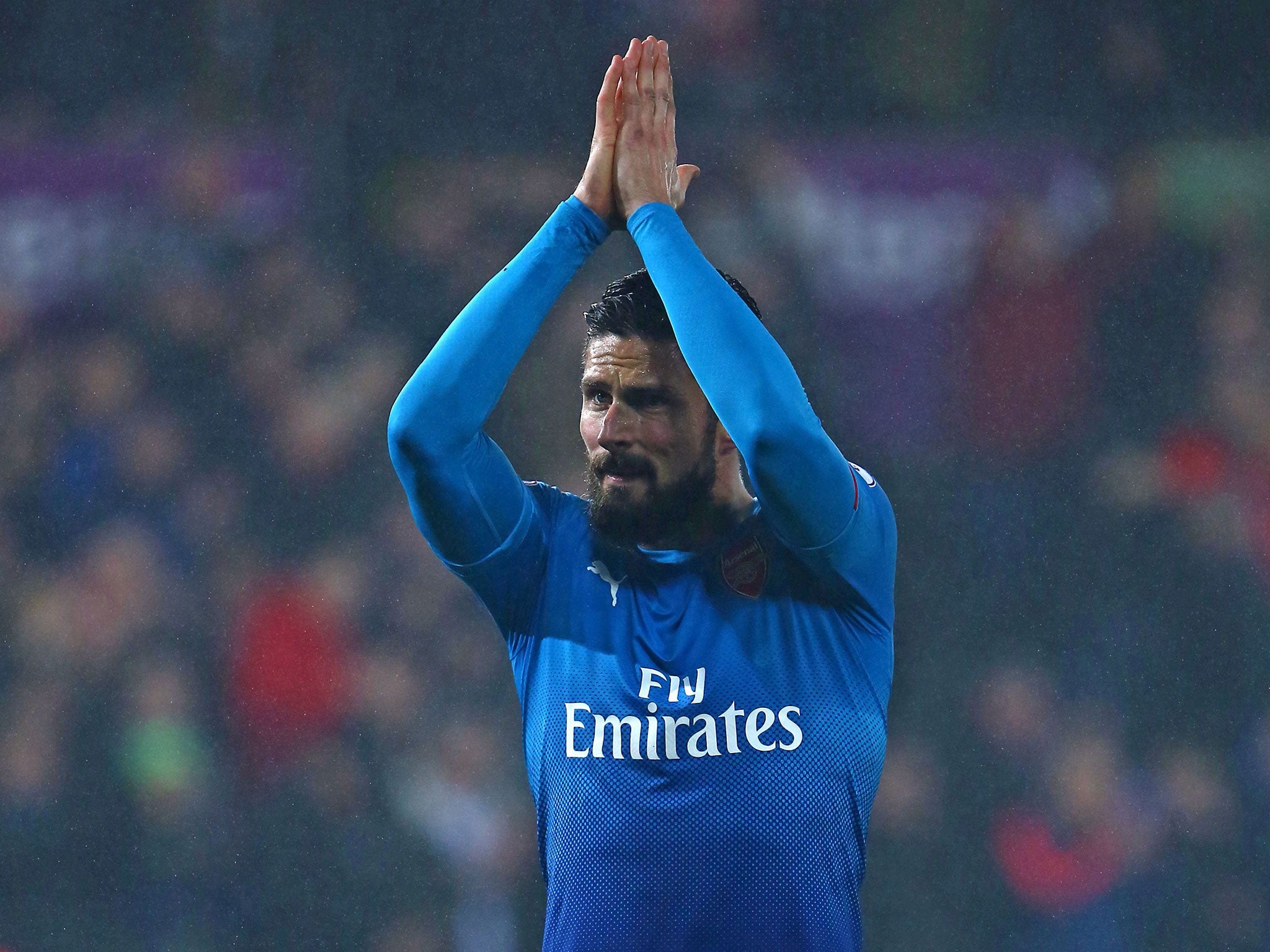 Olivier Giroud claps the travelling fans after Arsenal's defeat at Swansea