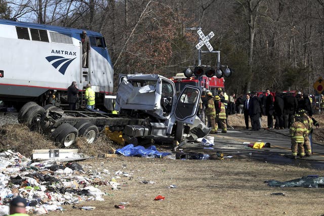 Emergency personnel work at the scene of a train crash involving a garbage truck in Crozet, Virginia
