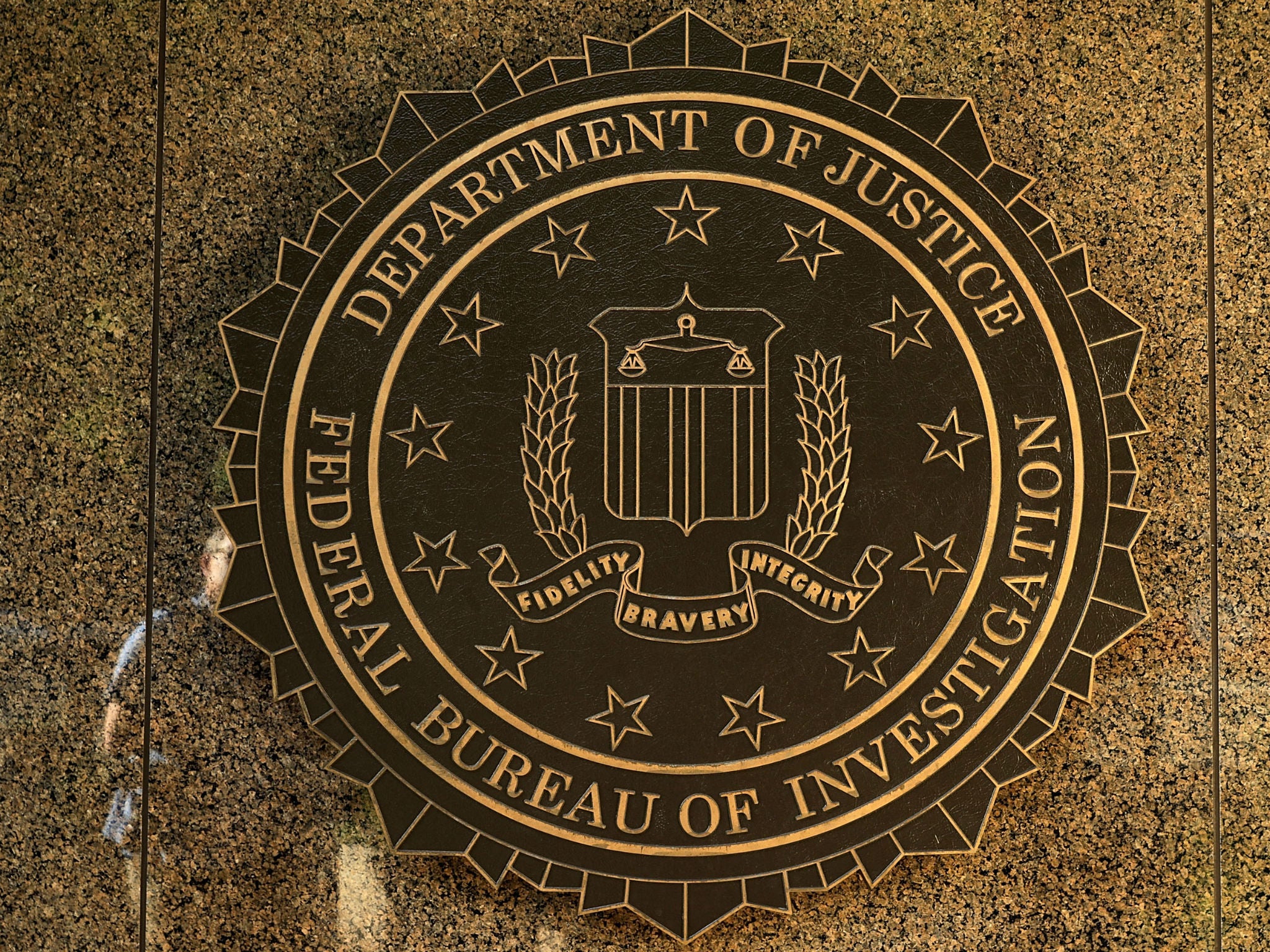 The seal of the Federal Bureau of Investigation hangs on the outside of the bureau's Washington, DC headquarters