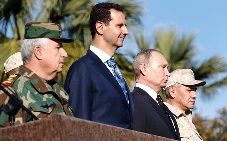 Bashar al-Assad and Vladimir Putin inspect a military parade in the northwestern Syrian province of Latakia