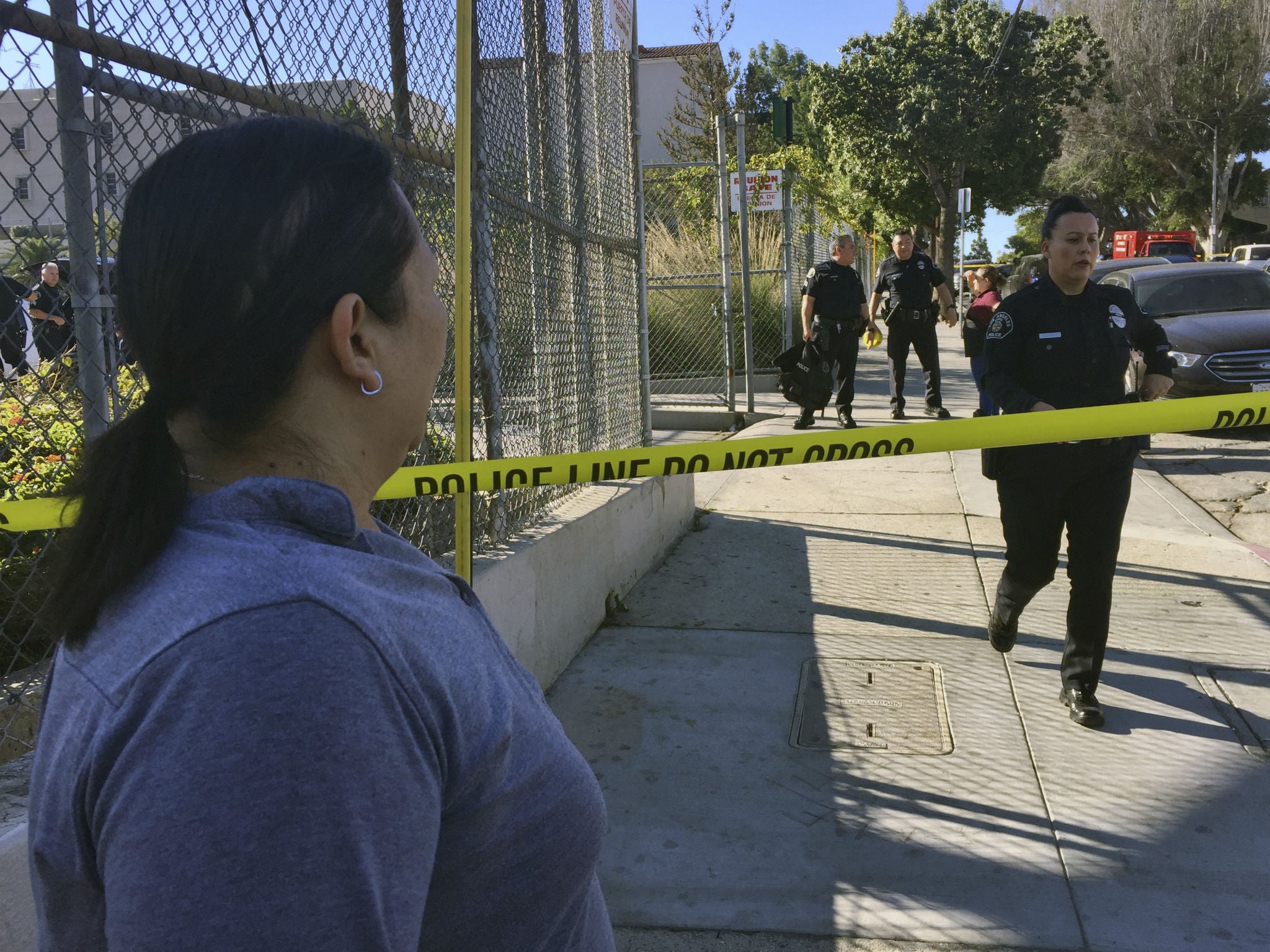 Los Angeles police officers close off a street where a shooting occurred at a middle school