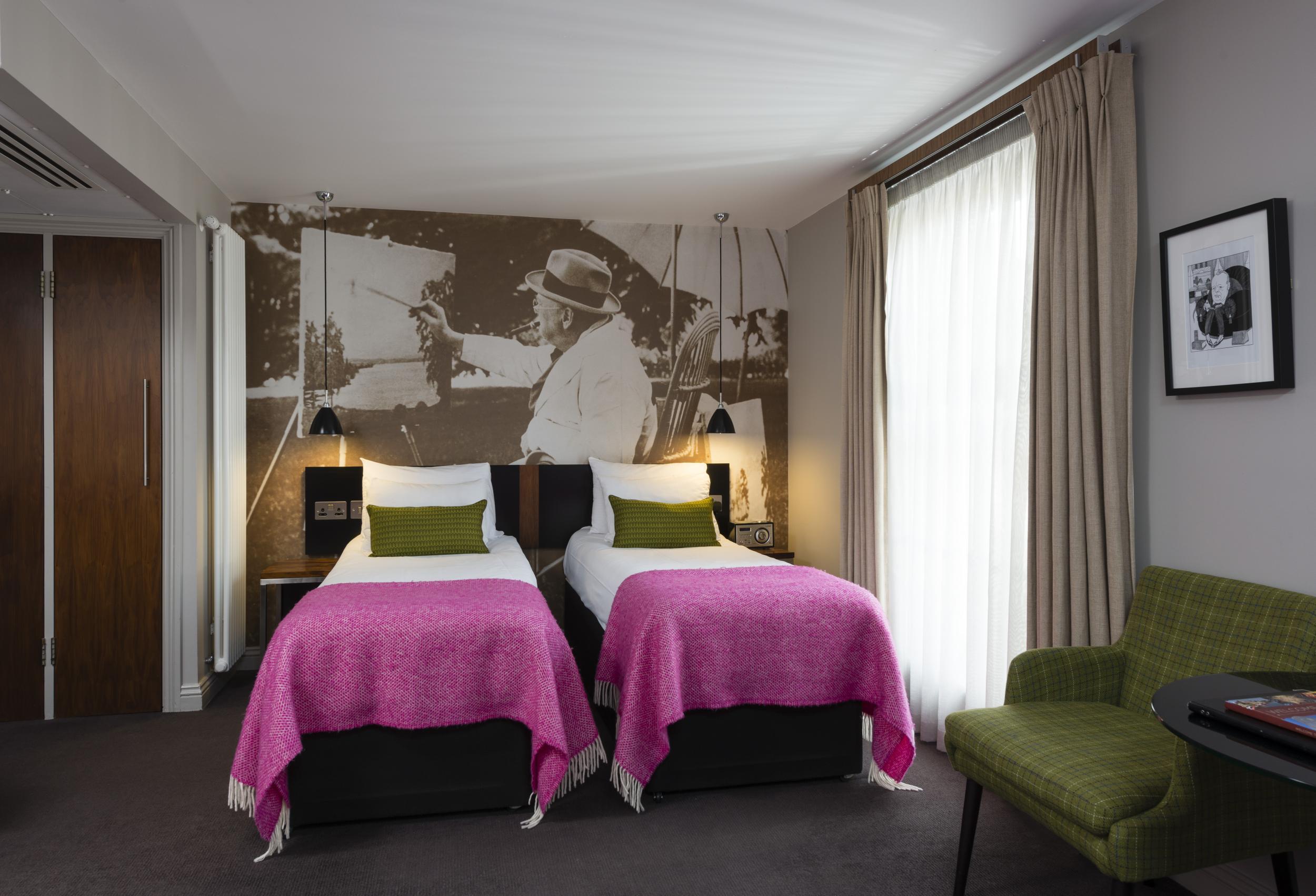 Hot pink bed sheets and a mural of you-know-who (The Churchill Hotel)