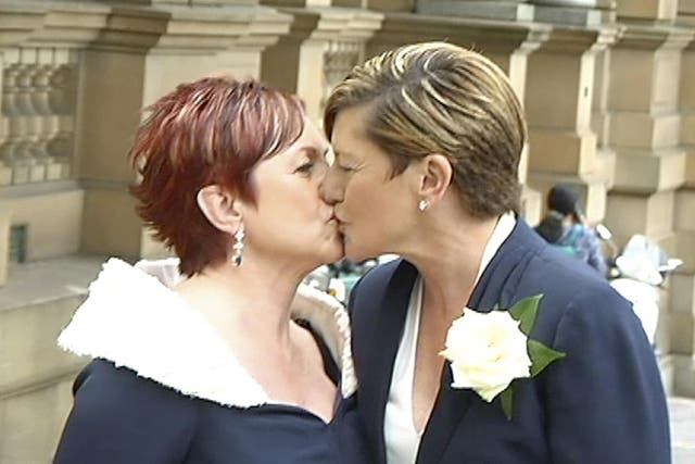 Christine Forster, right, kisses partner Virginia Flitcroft after their wedding