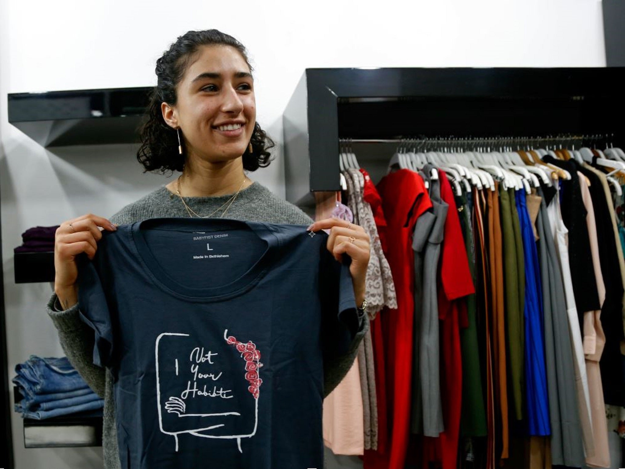 Palestinian-American Yasmeen Mjalli holds one of her T-shirt designs with the slogan 'Not Your Habibti (darling),' as a ready-made retort for cat calls