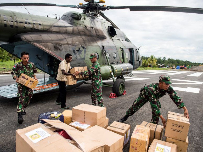 Indonesian soldiers unload food and medical aid in the Asmat district in the remote region of Papua, Indonesia.