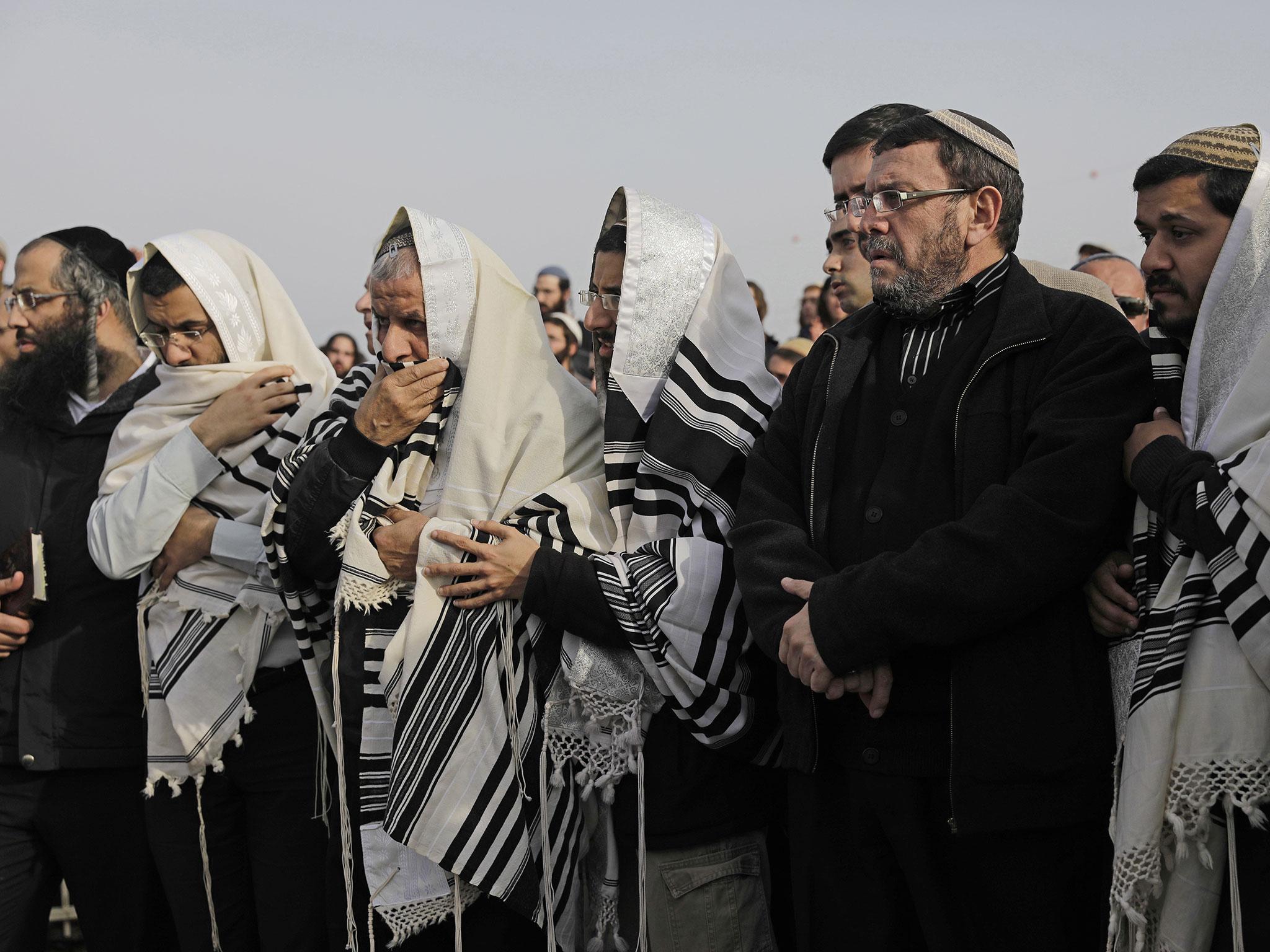 Israelis pray during the funeral of Rabbi Raziel Shevah in Havat Gilad, a currently unauthorised Israeli settlement outpost near the Palestinian city of Nablus