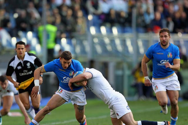 Tommaso Benvenuti is tackled by Owen Farrell