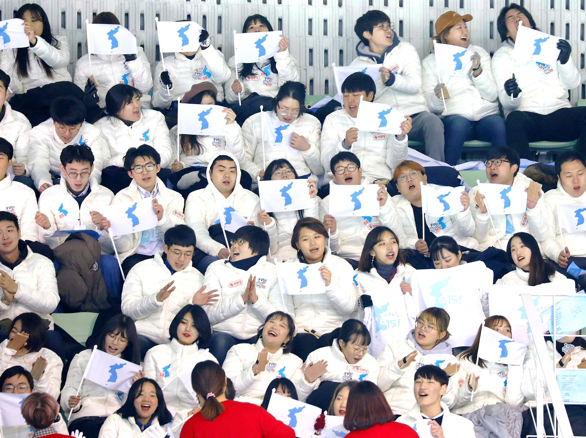 Fans hold up the Unification Flag, designed to represent both North and South