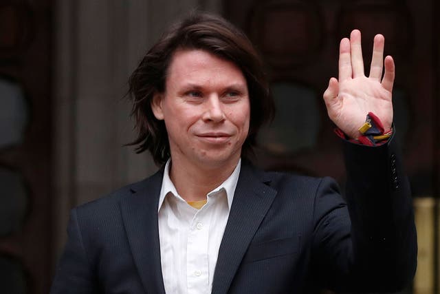 Lauri Love waves to supporters outside The Royal Courts of Justice in London on 5 February