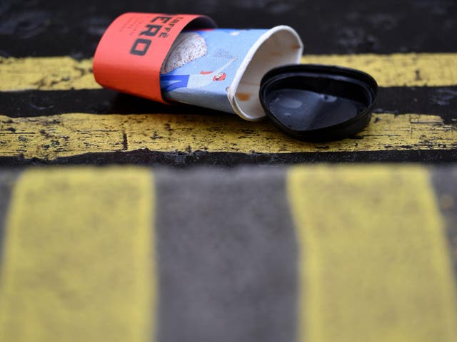 A flattened disposable coffee cup sits on a road in central London on January 5, 2018.