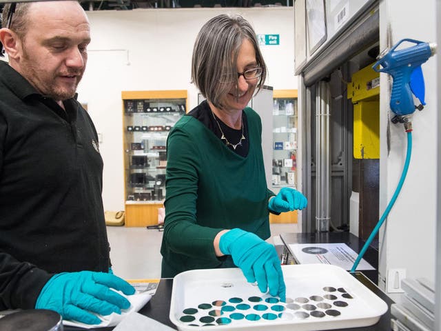 Dr Helen Pankhurst, great granddaughter of suffragette Emmeline Pankhurst, strikes a commemorative 50p coin to mark the centenary of the Representation of the People Act