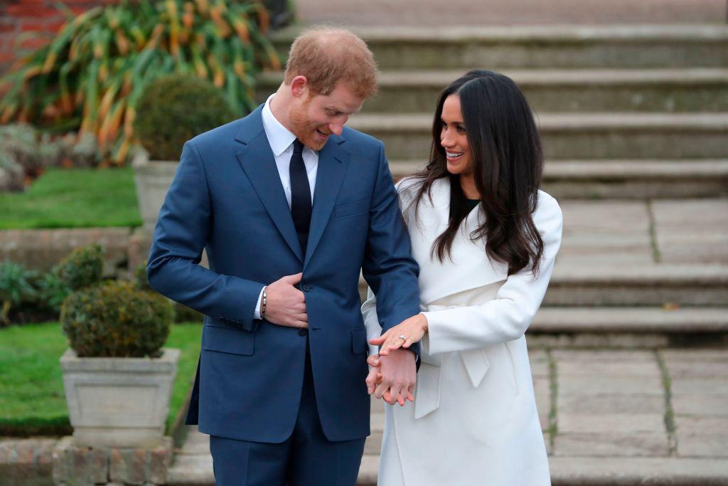 Prince Harry and Meghan Markle pose in the Sunken Garden at Kensington Palace on November 27 2017 following the announcement of their engagement.