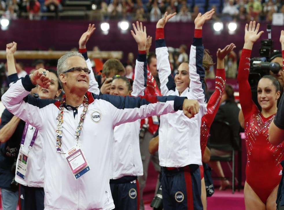 US women gymnastics team's coach John Geddert celebrates with the team after the artistic gymnastics event of the London Olympic Games