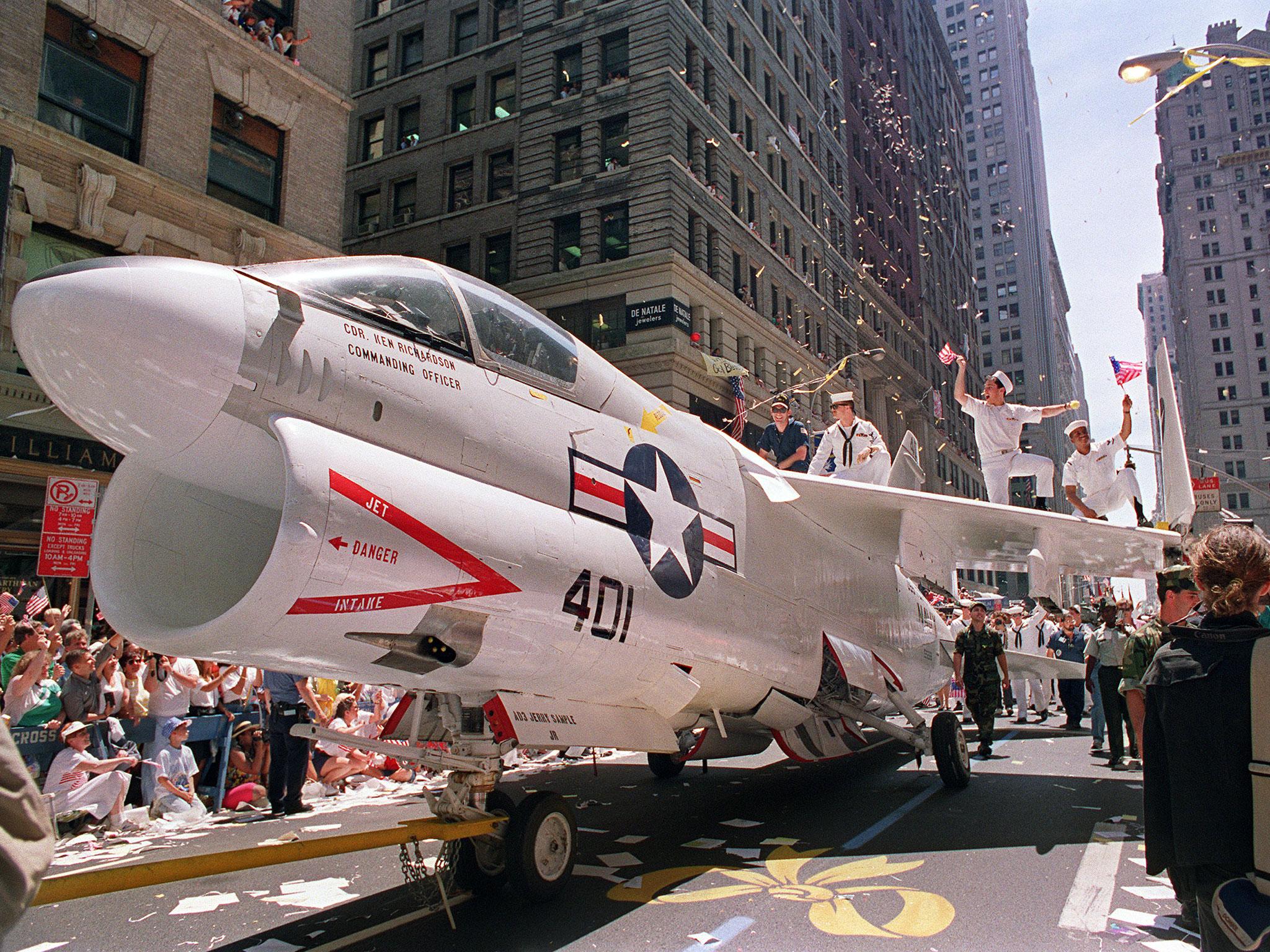 A Navy A-7 Corsair jet is pulled down Broadway Avenue as sailors rejoice on the wings during the Operation Welcome Home parade for returning Gulf War troops, when an estimated one million people came to welcome some 24,000 Desert Storm veterans