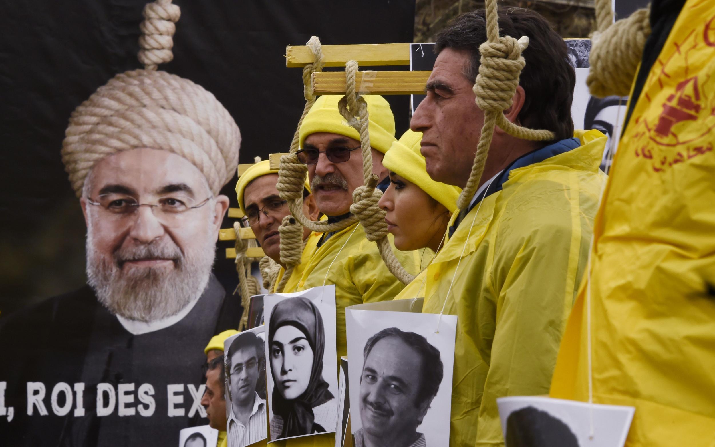 People hold placards displaying portraits of Iranians on death row during a demonstration denouncing Iran's use of the death penalty on 28 January 2016 in Paris, France
