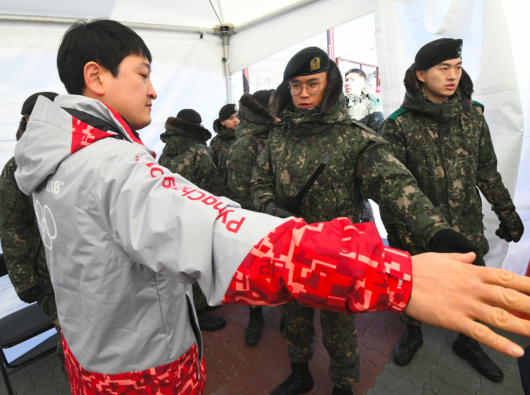 South Korean soldiers inspect a visitor at a security checkpoint