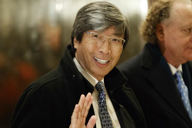 Pharmaceuticals billionaire Dr Patrick Soon-Shiong waves as he arrives in the lobby of Trump Tower 10 January 2017 for a meeting with the President-elect Donald Trump.