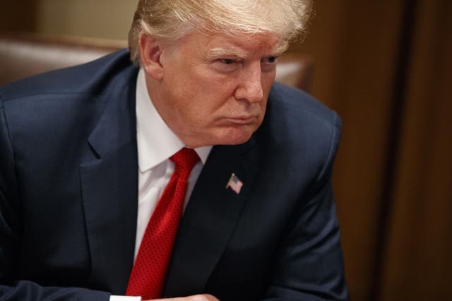 President Donald Trump listens during a meeting with law enforcement officials on the MS-13 street gang and border security