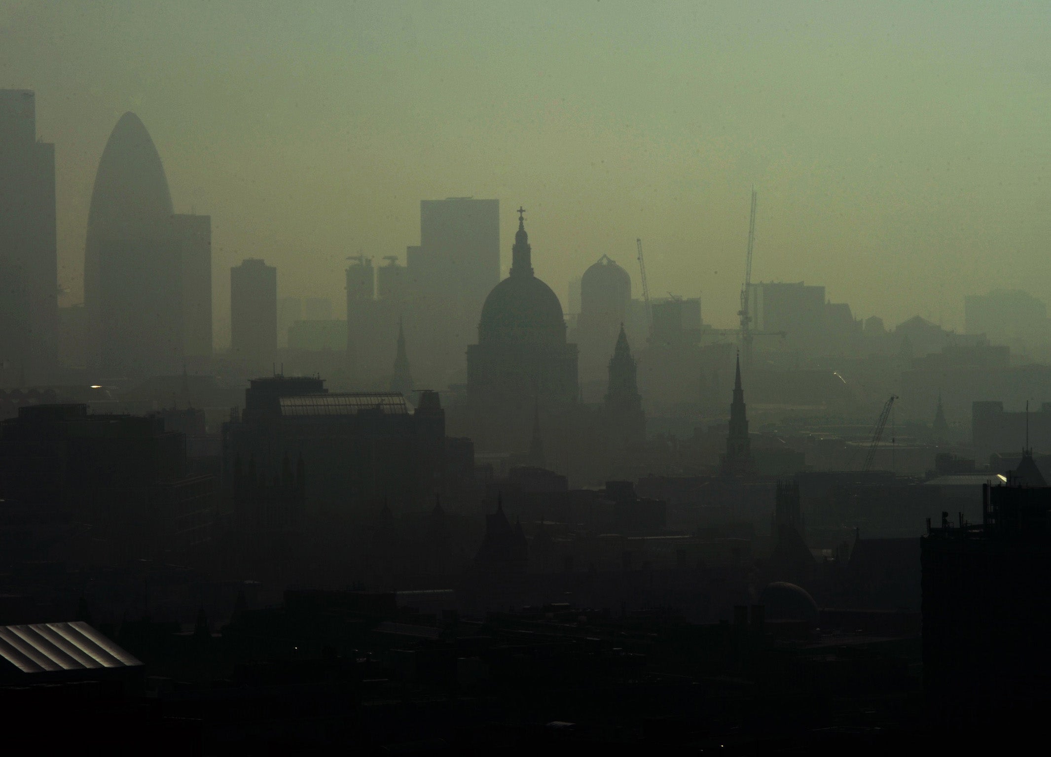 St. Paul's Cathedral is seen among the skyline through the smog in central London on April 22, 2011