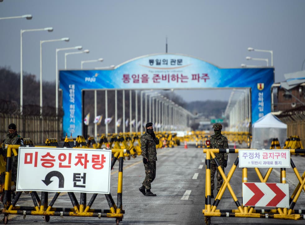 South Korean soldiers patrol the road connecting South and North Korea at the Unification Bridge near the Demilitarized Zone (DMZ) on 7 February 2018