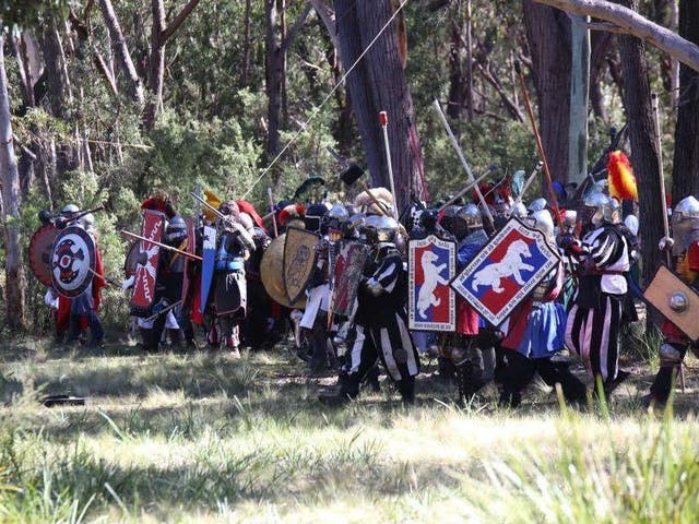 Members of the Society for Creative Anachronism participate in a battle