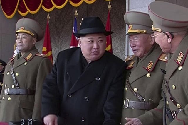 Kim Jong Un speaks with military officials during a military parade in Pyongyang