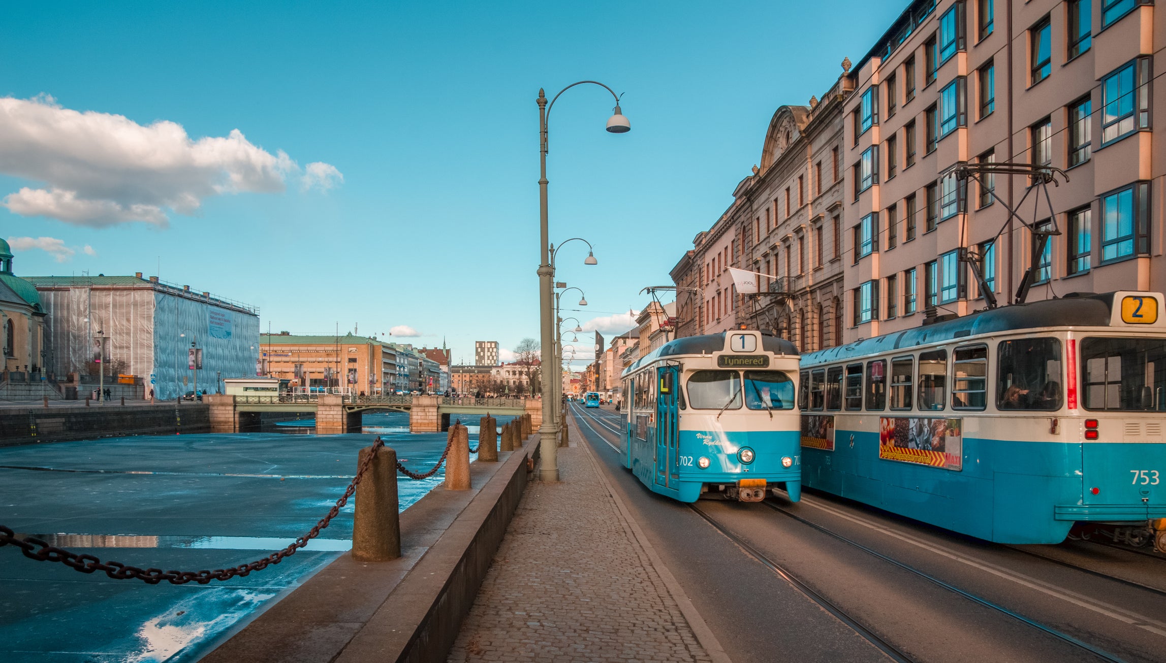 Blue trams travelling through the streets of Gothenburg