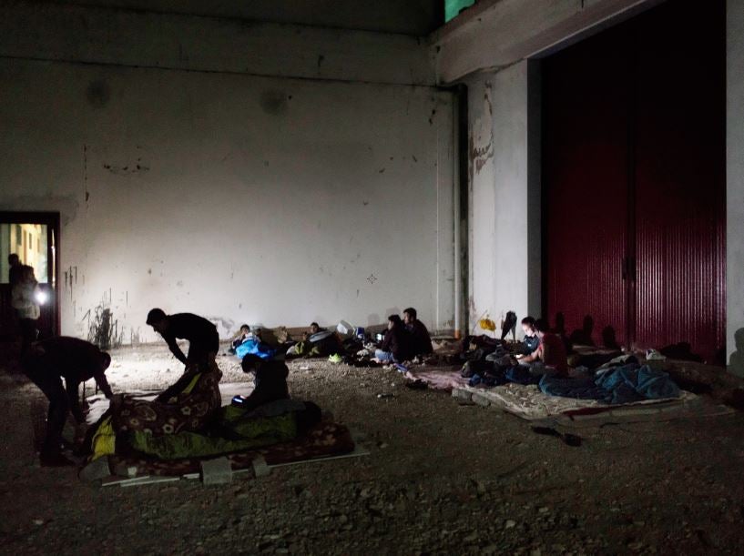 Migrants sleep in an abandoned warehouse in Pordenone, north-east Italy