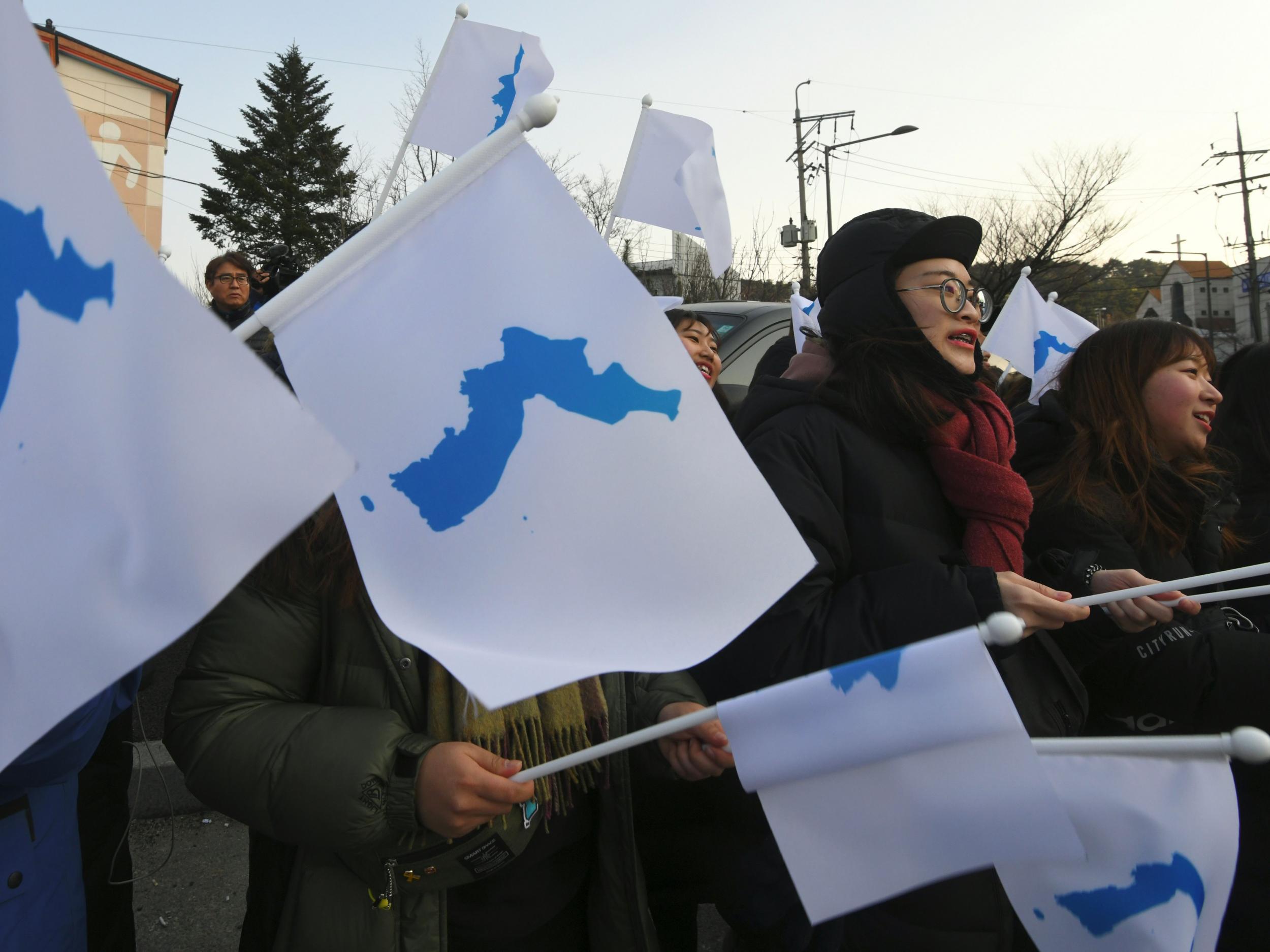 South Korean supporters wave ‘unification flags’ as they welcome North Korea’s art performers to Gangneung, the host city of the ice venues for the Pyeongchang Winter Olympic Games
