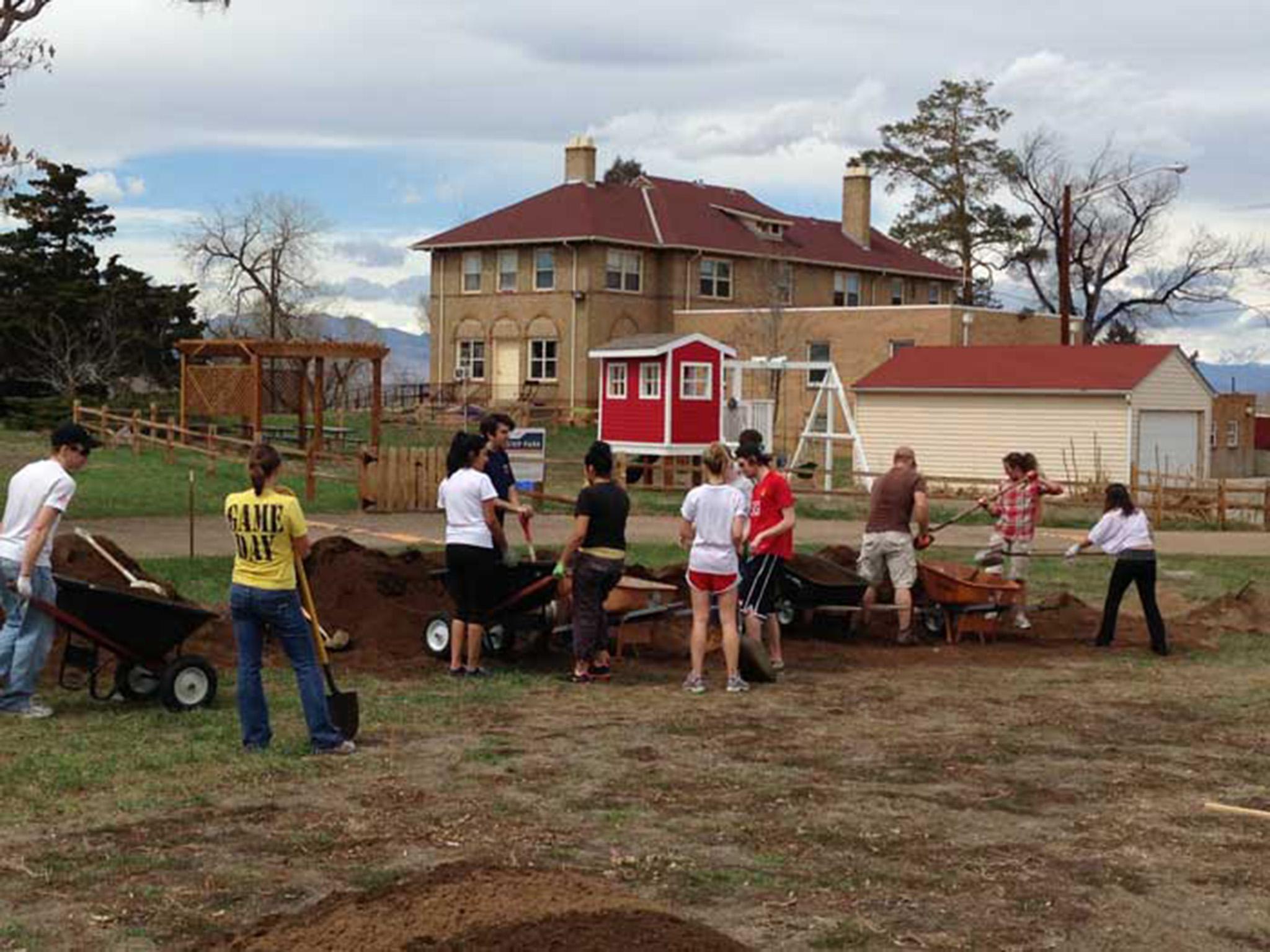 Dig in: members of the Aria community work on their garden together