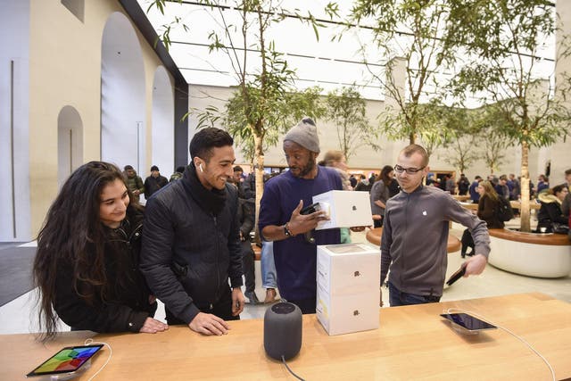 Customers look at The Apple HomePod, which is now available in stores in the US, UK and Australia, at Apple Store on Regent Street