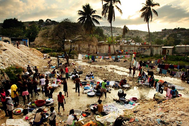 Survivors of the 2010 earthquake that killed more than 200,000 people in Haiti wash their clothes in Port au Prince
