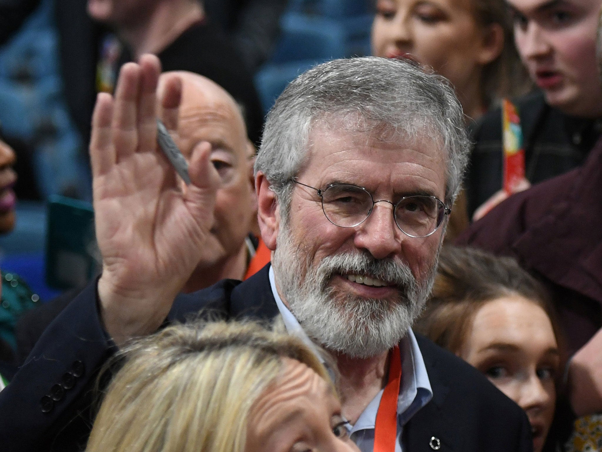 Sinn Fein's Gerry Adams waves as he leaves a special party conference where he formally stepped down