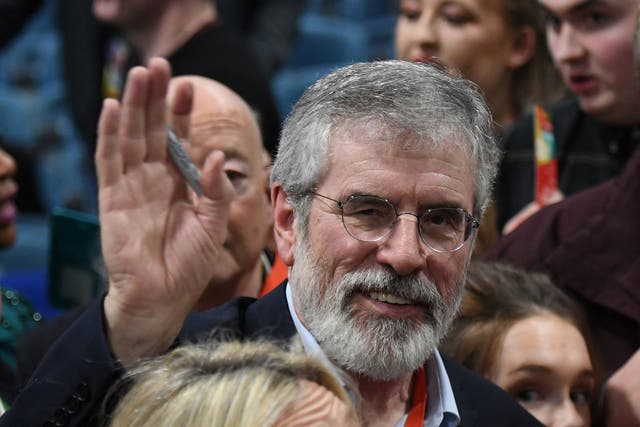 Sinn Fein's Gerry Adams waves as he leaves a special party conference where he formally stepped down