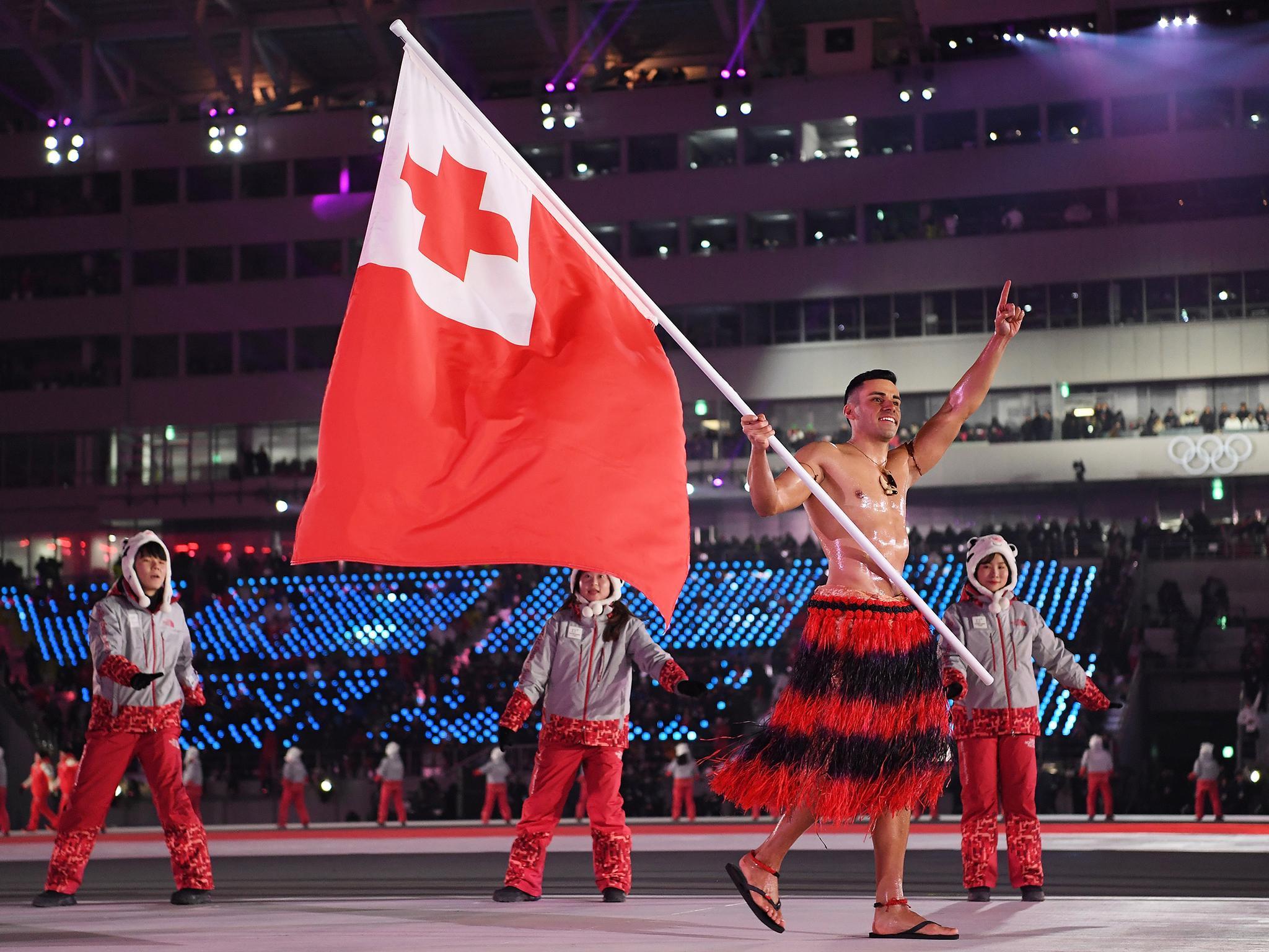 Pita Taufatofua appeared with just oil on his torso to ward off the cold Getty