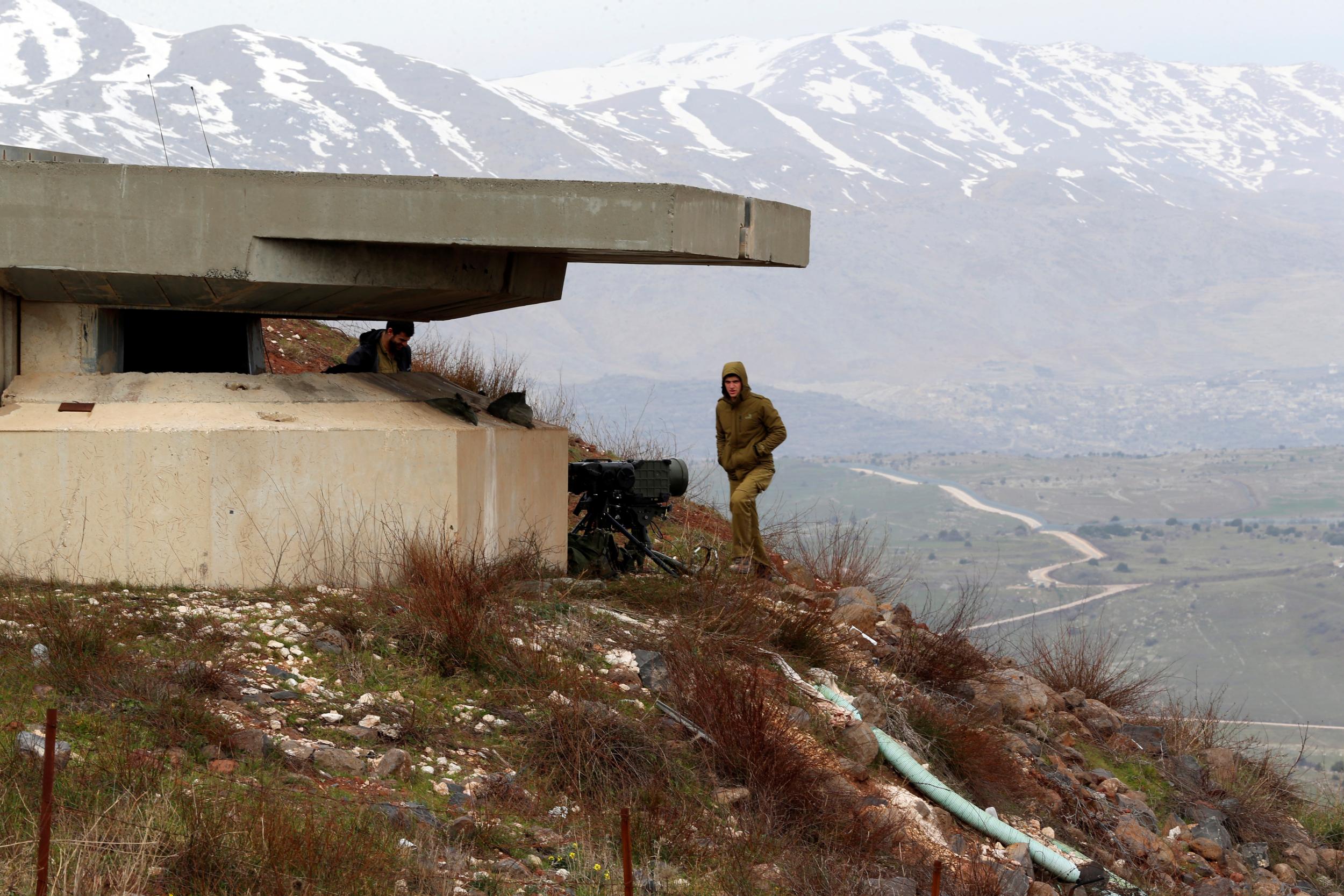 An Israeli soldier walks up to a military post close to the Druze village of Majdal Shams in the Israeli-occupied Golan Heights on 10 February 2018