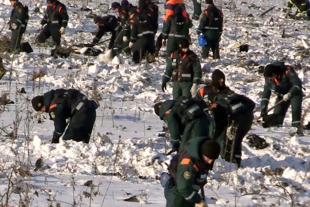 Rescuers search for human remains and collect plane debris at the site of the crashed Russian Saratov Airlines passenger plane outside Moscow