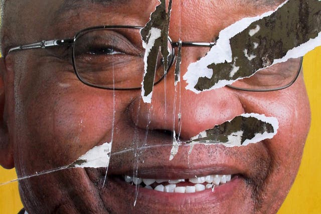 A torn African National Congress (ANC) election poster shows the face of Jacob Zuma