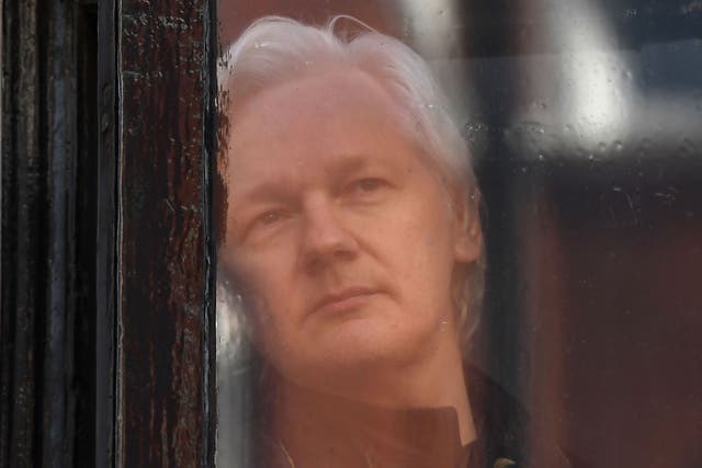 Wikileaks founder Julian Assange appears at the window at the Ecuadorian embassy in London