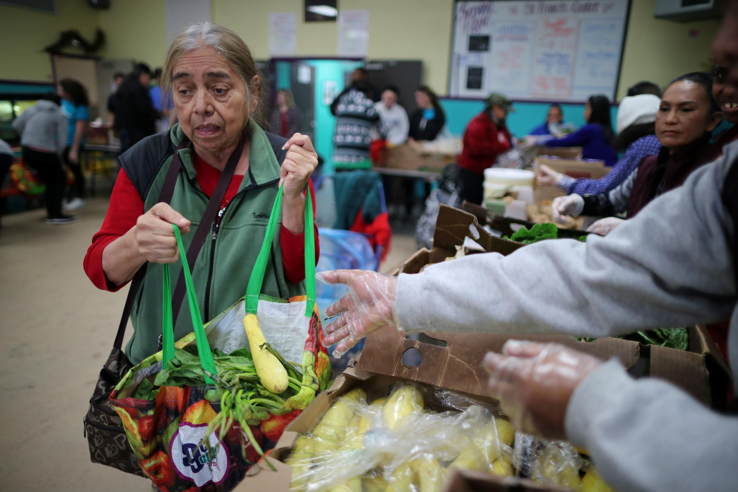 A woman collects provisions at a food bank for the poor in Los Angeles