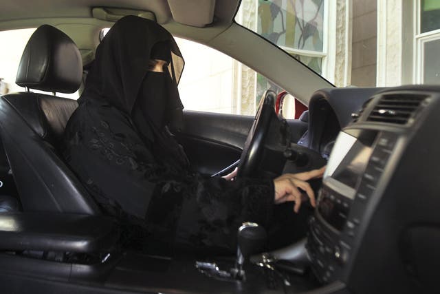 A woman defies the law to drive a car in Saudi Arabia on 22 October 2013