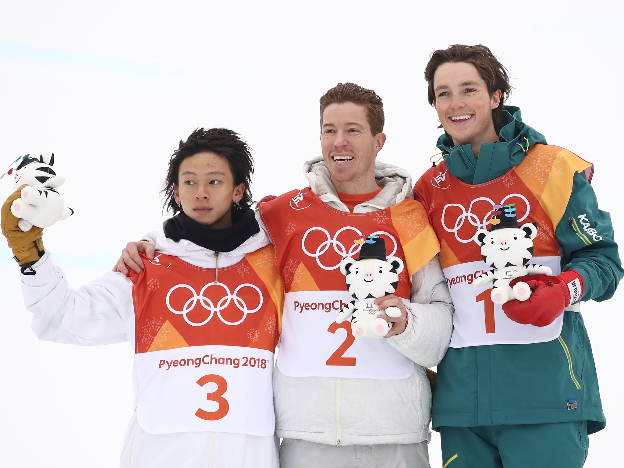 White (centre) beat Ayumu Hirano (left) and Scotty James (right) to claim gold on Tuesday