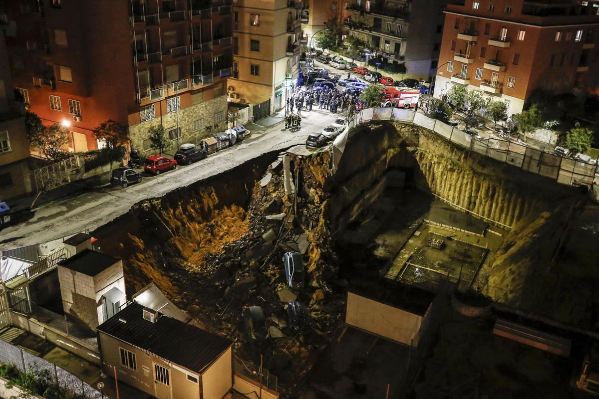 Huge sinkhole swallows cars and forces families to evacuate homes in
