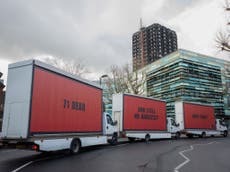 Three billboards parked outside Grenfell Tower demand answers