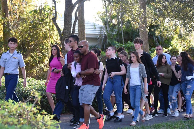 Students are led away after a  gunman opened fire at Marjory Stoneman Douglas High School in Parkland, Florida