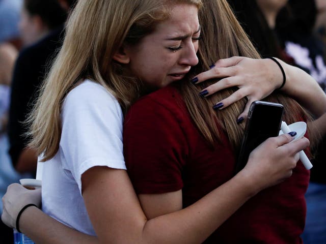 Students mourn during a candlelight vigil for victims of a shooting at Marjory Stoneman Douglas High School, in Parkland, Florida
